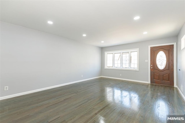 entrance foyer featuring dark wood-type flooring, recessed lighting, and baseboards