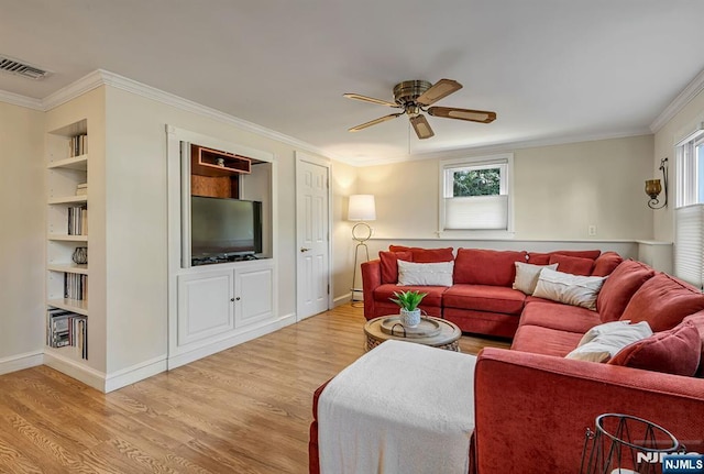 living room featuring a wealth of natural light, visible vents, crown molding, and light wood-style floors