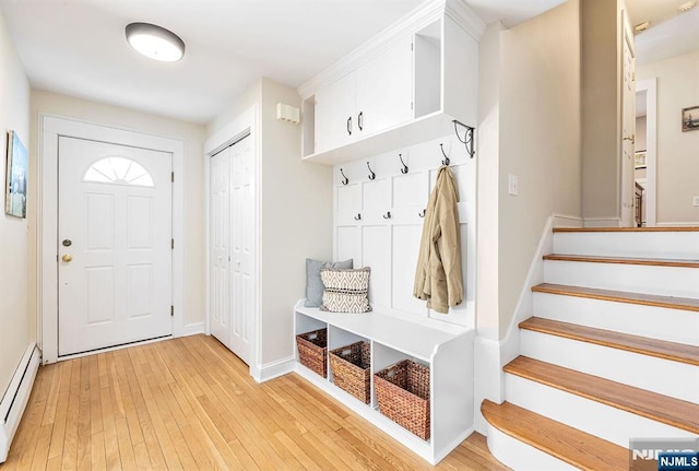 mudroom featuring light wood-style flooring, baseboards, and baseboard heating