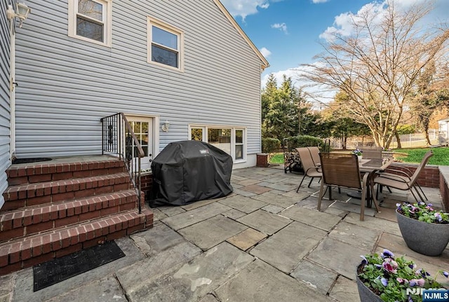 view of patio featuring outdoor dining area, fence, and grilling area