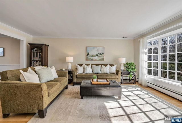 living room featuring visible vents, light wood-style flooring, and ornamental molding