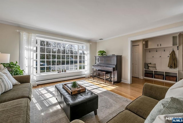 living area with baseboard heating, wood finished floors, baseboards, and ornamental molding