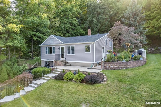 ranch-style house with a chimney and a front lawn