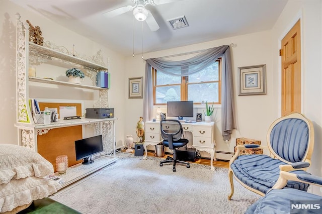 office area with visible vents, baseboard heating, and a ceiling fan