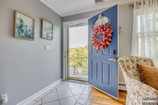 entryway featuring baseboards, visible vents, crown molding, a baseboard heating unit, and light tile patterned flooring