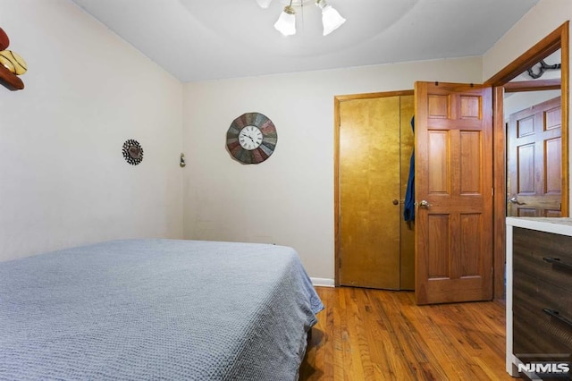 bedroom with ceiling fan and wood finished floors