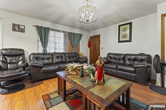 living room featuring light wood-style floors and a notable chandelier