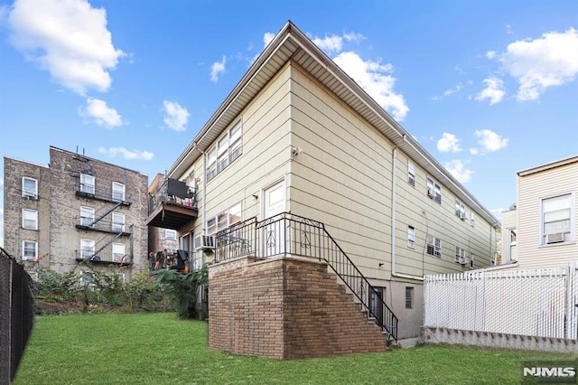 back of house with stairs, cooling unit, a yard, and fence