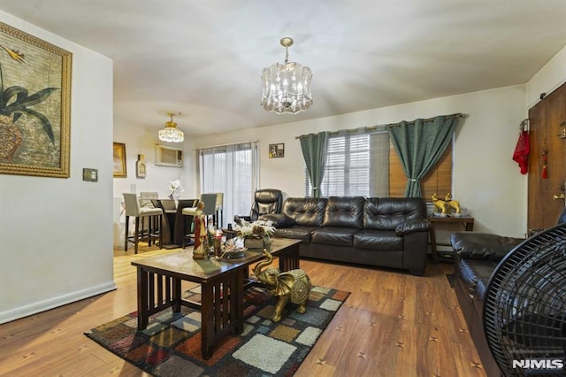 living room with wood-type flooring and an inviting chandelier