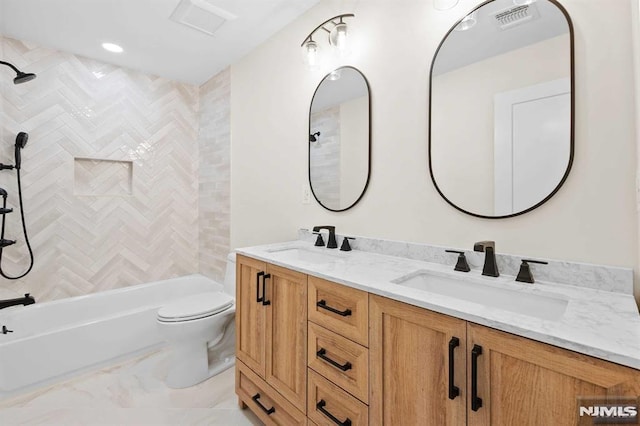 full bath with visible vents, a sink, toilet, and double vanity