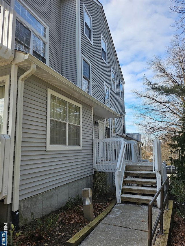 view of property exterior featuring a wooden deck