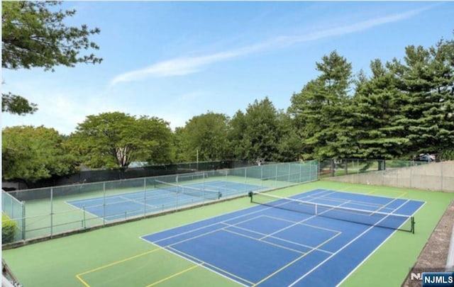 view of sport court featuring fence