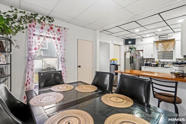 dining room with a drop ceiling