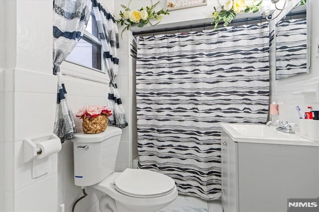 bathroom with a shower with curtain, marble finish floor, vanity, and toilet