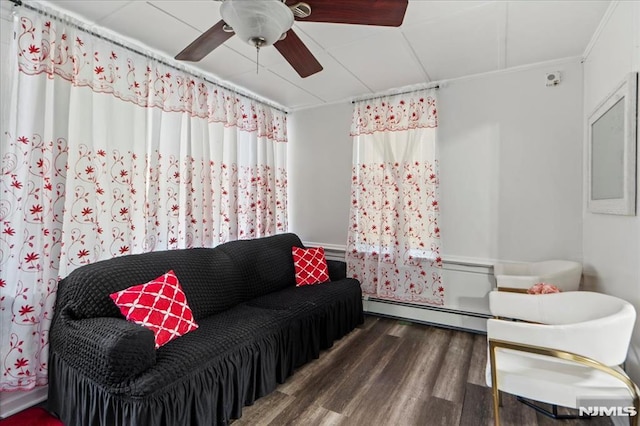 living room featuring a baseboard radiator, ceiling fan, and wood finished floors