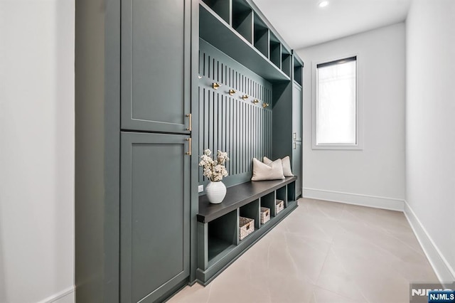 mudroom with recessed lighting and baseboards