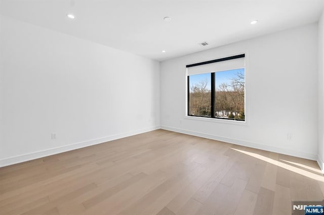 unfurnished room featuring visible vents, recessed lighting, light wood-style flooring, and baseboards