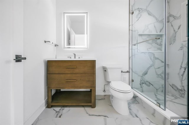 bathroom featuring marble finish floor, toilet, vanity, and a marble finish shower