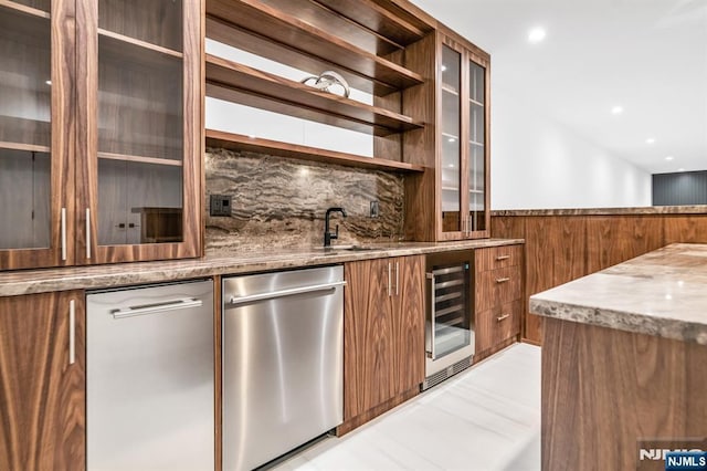 bar featuring wine cooler, a wainscoted wall, wood walls, a sink, and dishwasher