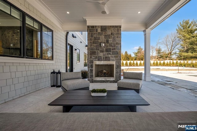 view of patio / terrace with a ceiling fan and an outdoor stone fireplace