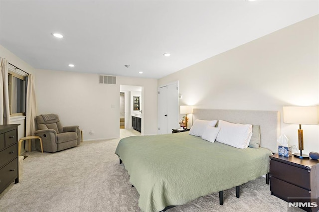 bedroom with recessed lighting, visible vents, light carpet, and connected bathroom