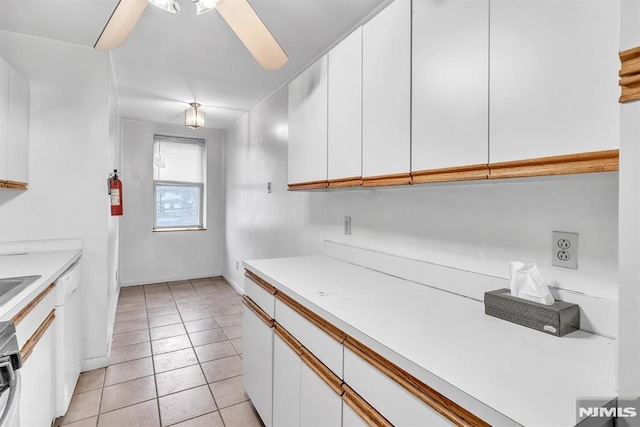 kitchen with light tile patterned floors, white cabinetry, and light countertops