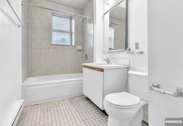 full bathroom with toilet, baseboard heating, tub / shower combination, vanity, and tile patterned floors