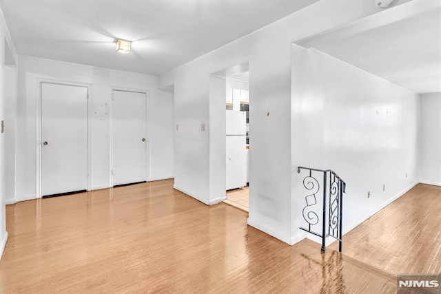 spare room with wood finished floors and baseboards