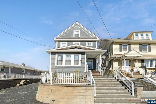 view of front of house featuring covered porch and fence