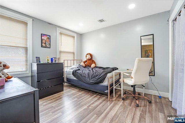 bedroom with recessed lighting, wood finished floors, visible vents, and baseboards