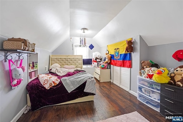 bedroom featuring baseboards, wood-type flooring, and lofted ceiling