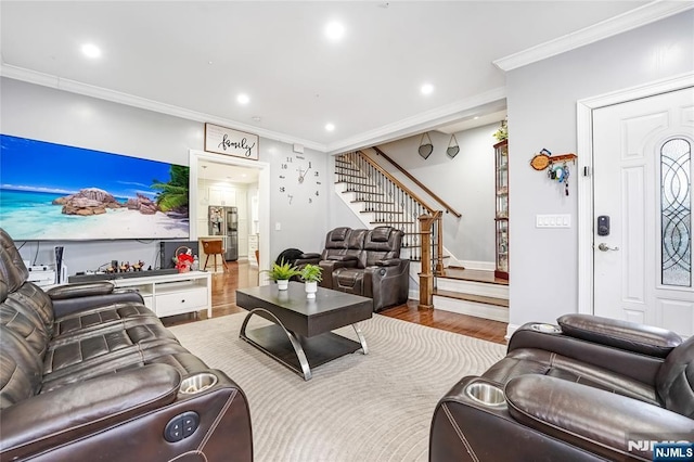 living area with recessed lighting, stairway, wood finished floors, and ornamental molding