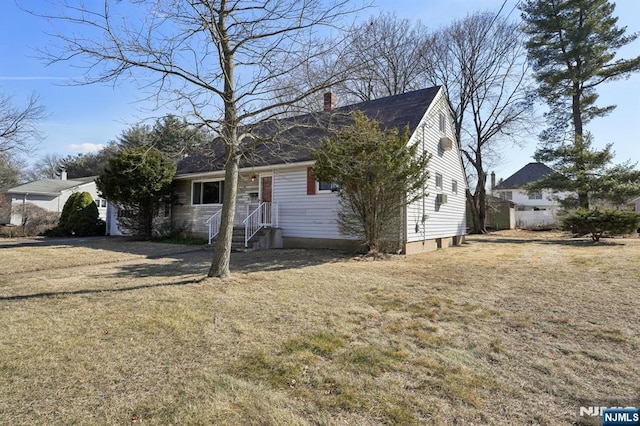 view of front of house featuring a front yard and a chimney