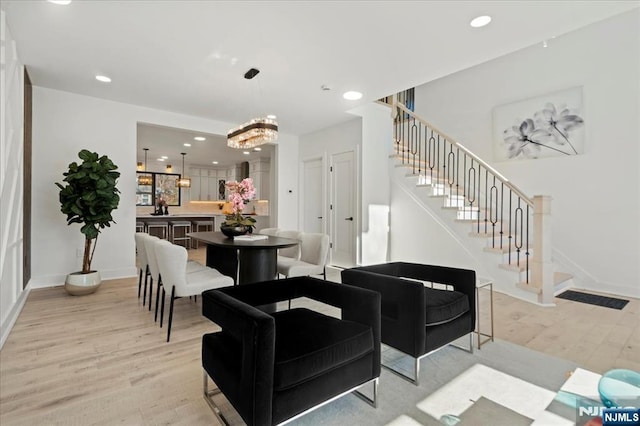 living room with recessed lighting, baseboards, stairway, and light wood finished floors