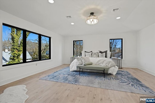 bedroom featuring baseboards, light wood finished floors, visible vents, and recessed lighting