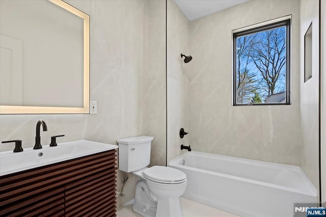 full bathroom featuring washtub / shower combination, vanity, and toilet