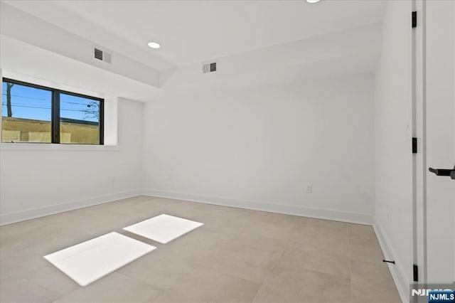 unfurnished room with baseboards, visible vents, and recessed lighting