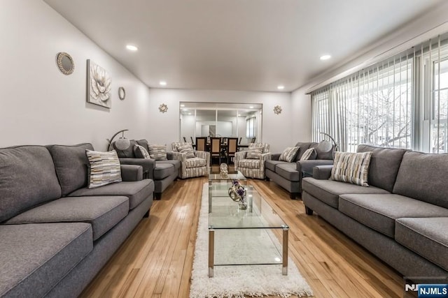 living area with light wood finished floors and recessed lighting