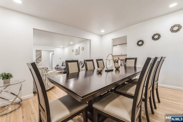 dining room with recessed lighting, light wood-type flooring, and baseboards