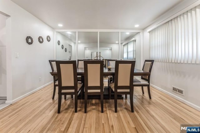 dining space with recessed lighting, wood finished floors, visible vents, and baseboards