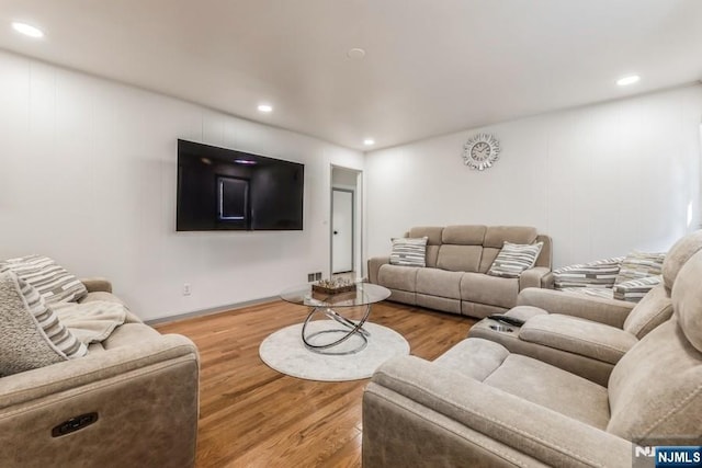 living area with wood finished floors and recessed lighting