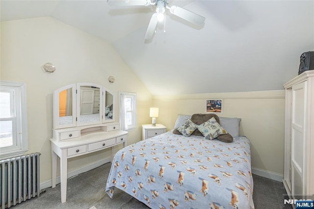 carpeted bedroom featuring baseboards, vaulted ceiling, radiator heating unit, and ceiling fan