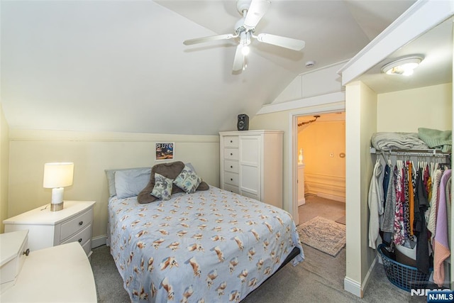 carpeted bedroom with lofted ceiling, ensuite bath, ceiling fan, and baseboards