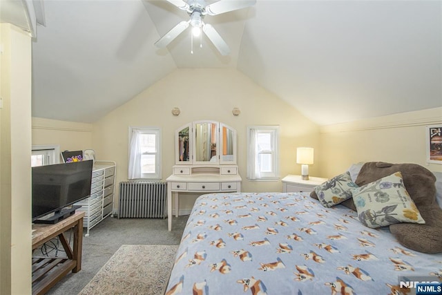 carpeted bedroom featuring radiator, vaulted ceiling, and ceiling fan