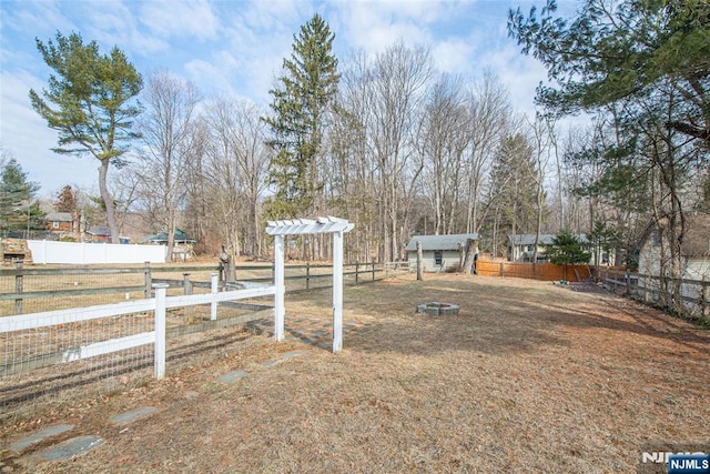 view of yard with fence and an outdoor structure