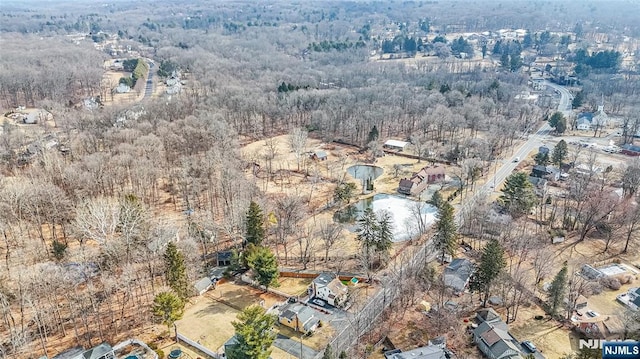 birds eye view of property with a wooded view