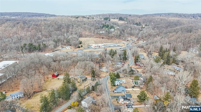 birds eye view of property with a wooded view