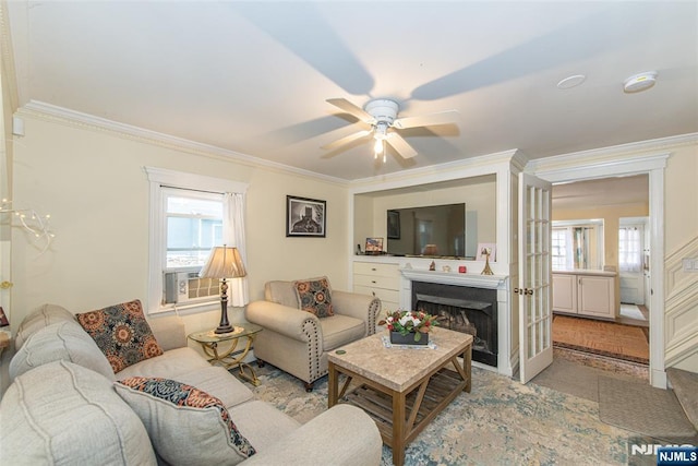 living area featuring crown molding, a fireplace, ceiling fan, and cooling unit