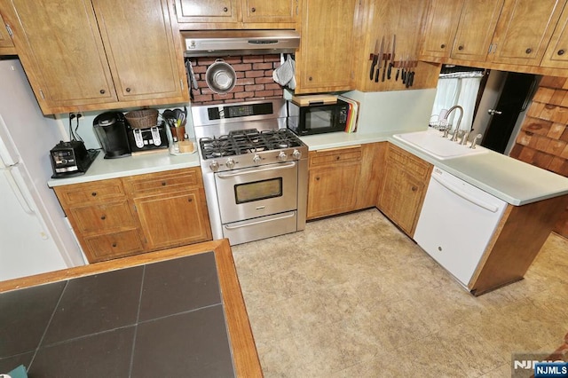 kitchen with light countertops, brown cabinetry, a sink, white appliances, and under cabinet range hood