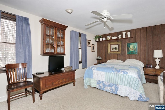 bedroom featuring carpet floors and wood walls